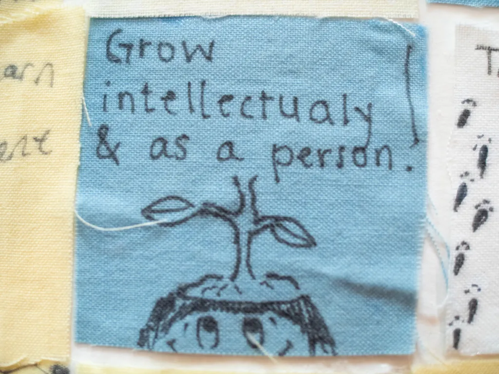 Close up of a senior quilt square that reads, "grow intellectually and as a person."
