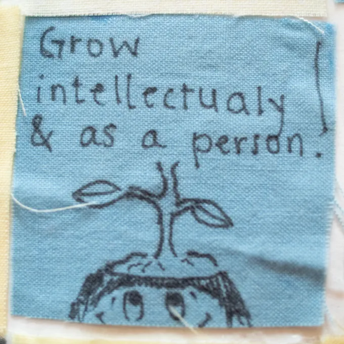 Close up of a senior quilt square that reads, "grow intellectually and as a person."